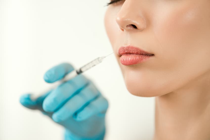 Medical Doctor injecting woman lips
